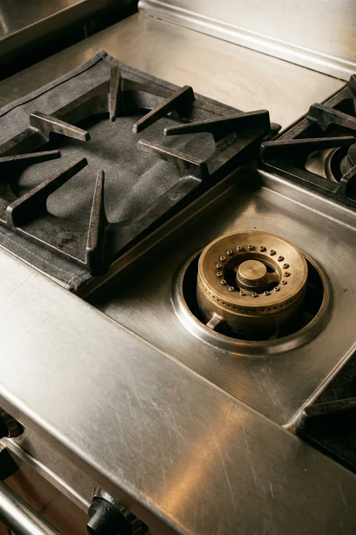 Wolf range burner with the grate lifted and cap removed